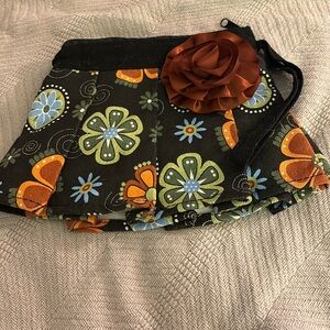 Cute little purse shaped as a skirt.  With flower motif.